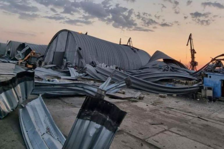 Damaged Ukrainian grain storage beside port cranes