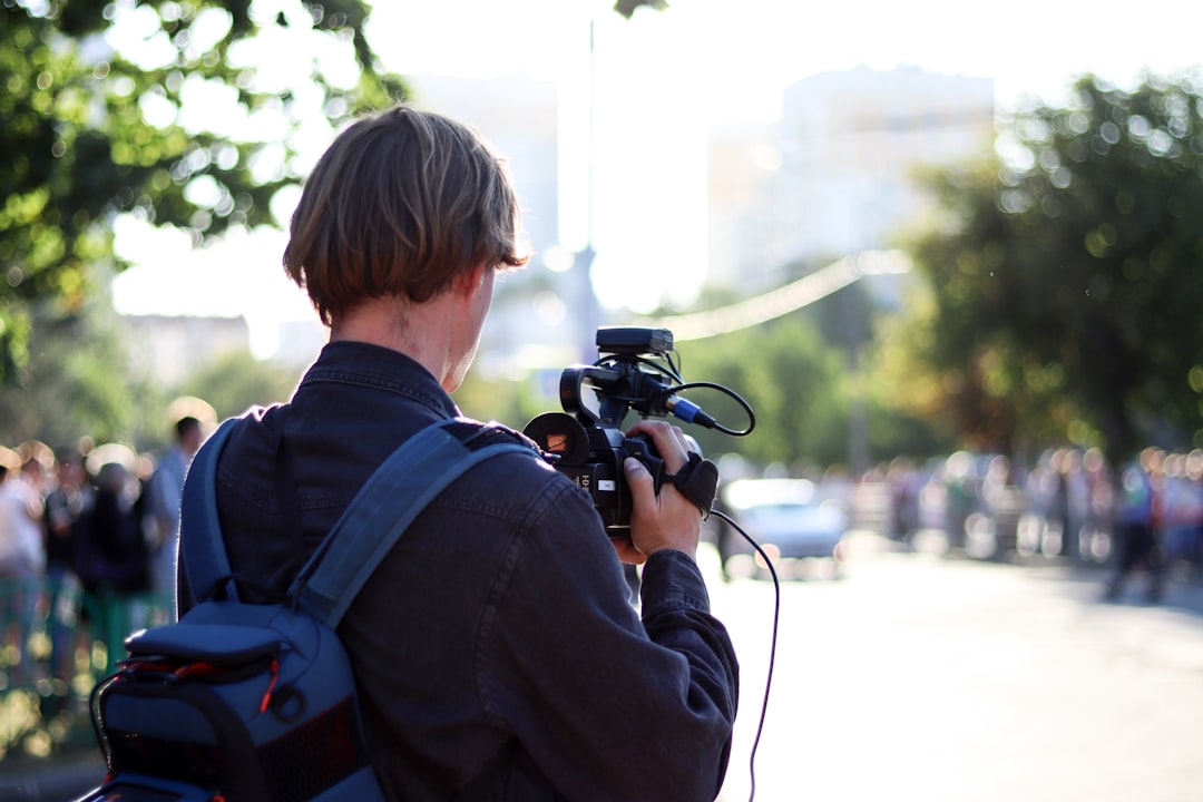 A field reporter documenting events with a camera